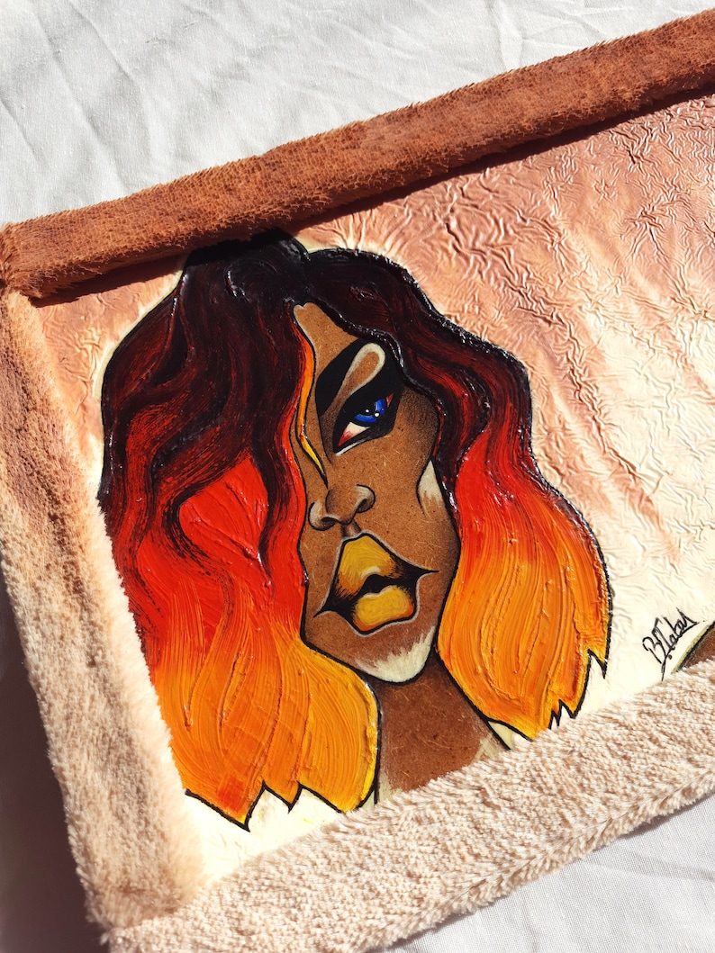 May include: A painting of a woman with long, orange and red hair. Her eyes are blue and her lips are yellow. The background is a light brown colour.