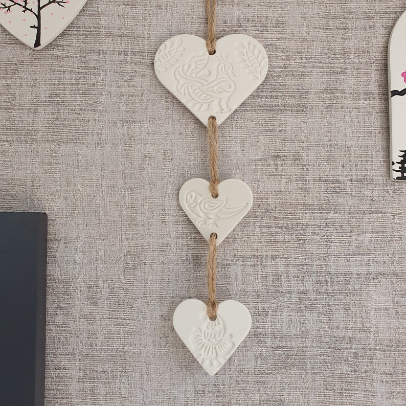 White clay hanging trio of hearts with peacock henna style design on natural twine. Wall hanging. Heart wall. Gift. Valentine's. Decoration. image 2