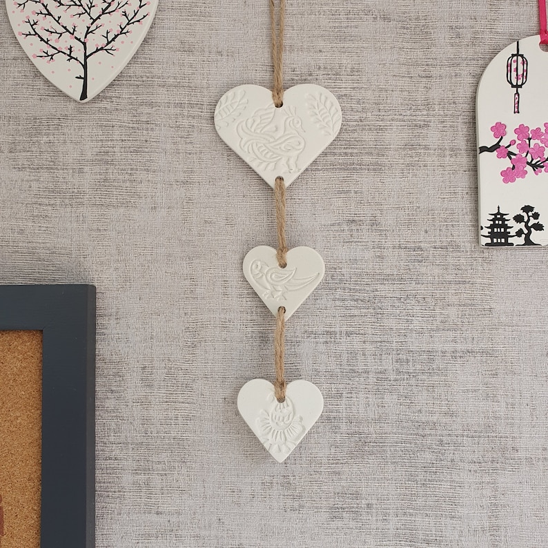 White clay hanging trio of hearts with peacock henna style design on natural twine. Wall hanging. Heart wall. Gift. Valentine's. Decoration. image 1