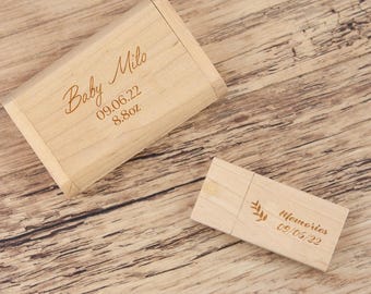 May include: A light-colored wooden USB flash drive and matching box. The box is engraved with "Baby Milo", a date, and "8.8oz". The USB drive is engraved with "Memories" and a date. The items are on a wooden surface.
