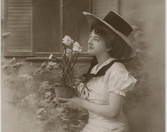 Antique postcard: In My Garden, woman with flowers and wide-brimmed hat, publisher E A Schwerdtfeger, c 1910s, 86 x 136 mm