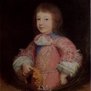 May include: Portrait of a young person in a pink and white ornate outfit, holding a gold object. The person has light brown hair and is set against a dark background. The clothing features intricate lace and ribbon details.