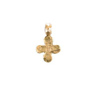 May include: A gold-toned metal pendant in the shape of a four-leaf clover.