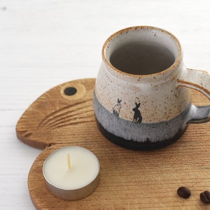 Dinky ceramic espresso cup with 2 rabbits out at dawn, glazed in blue and white, lovely gift for lovers of rabbits and hares