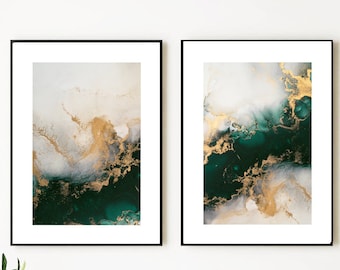 May include: Two framed abstract art prints with a green and gold color scheme. The prints are hanging on a white wall above a marble countertop.
