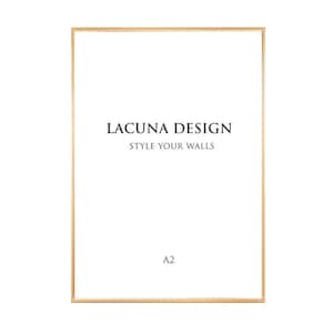 May include: A gold-coloured frame with the text "LACUNA DESIGN STYLE YOUR WALLS" and "A2" inside the frame.