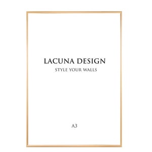 May include: A gold-coloured frame with the text "LACUNA DESIGN STYLE YOUR WALLS" and "A3" in black text.