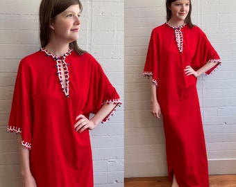 May include: A long, flowing red dress with short sleeves and a split hem. The neckline and sleeve edges are trimmed with white lace and small blue and red beads. The dress has a loose, comfortable fit.