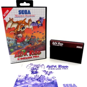 May include: A SEGA Master System video game box set for "Alex Kidd in Nightmare World." The box features a colorful illustration of a character in a red outfit, a dinosaur, and bats. The set includes the game cartridge and instruction manual.