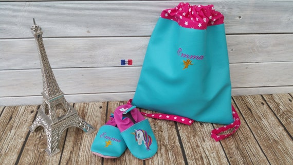 Set consisting of a mother's backpack and a pair of soft slippers