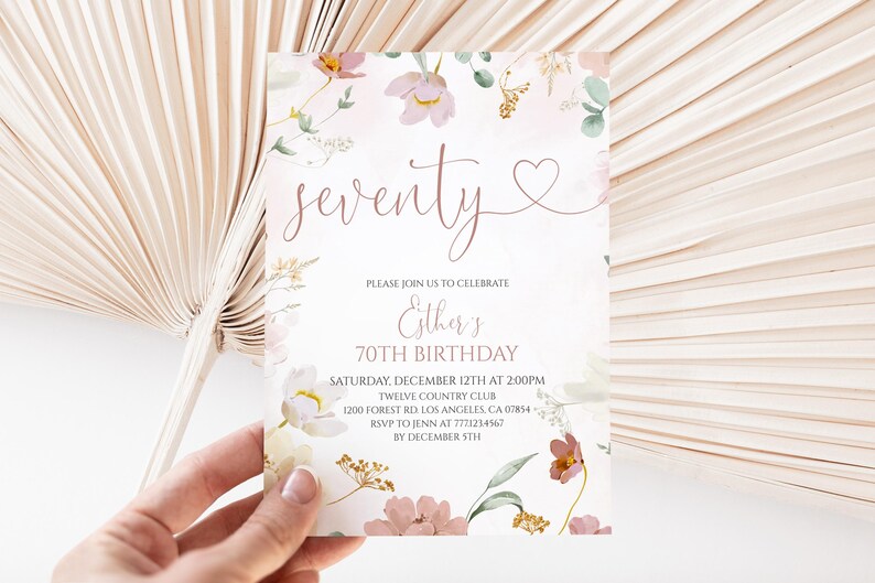 May include: A rectangular birthday invitation card featuring a floral design with pink, white, and gold botanical illustrations. The text reads: seventy, Esther's 70TH BIRTHDAY, SATURDAY, DECEMBER 12TH AT 2:00PM, TWELVE COUNTRY CLUB, 1200 FOREST RD, LOS ANGELES, CA 07854, RSVP TO JENN AT 7771234567 BY DECEMBER 5TH.