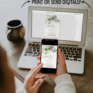 May include: A digital birthday invitation template displayed on a laptop screen and a smartphone screen. The invitation features a floral design with green leaves and the text seventy, along with placeholder details for a 70th birthday celebration.