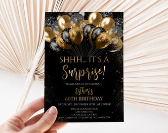 May include: A rectangular birthday invitation card with a black background featuring gold and black balloons at the top. The text reads: SHHH... IT'S A Surprise! PLEASE JOIN US TO CELEBRATE ESTHER'S 60TH BIRTHDAY SATURDAY | DECEMBER 12TH | AT 2:00PM TWELVE COUNTRY CLUB 1200 FOREST RD. LOS ANGELES, CA 07854 RSVP TO JENN AT 7771234567 BY DECEMBER 5TH.