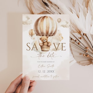 May include: A baby shower invitation card with a watercolor illustration of a teddy bear in a hot air balloon. The card reads "SAVE the date" and includes details for Esther Smith's baby shower, with a date of 12.12.20XX.