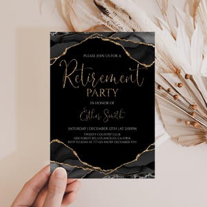 May include: Black and gold retirement party invitation. The invitation features elegant gold script that reads "Retirement Party" and includes event details. The invitation is held in a hand, with a neutral background.