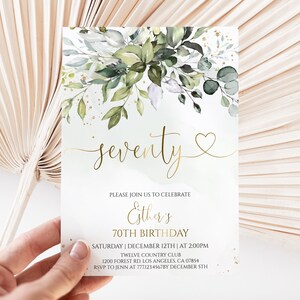 May include: A rectangular birthday invitation card featuring a watercolor illustration of green leaves and gold flecks at the top. The text reads: seventy, PLEASE JOIN US TO CELEBRATE, Esther's 70TH BIRTHDAY, SATURDAY | DECEMBER 12TH | AT 2:00PM, TWELVE COUNTRY CLUB, 1200 FOREST RD. LOS ANGELES, CA 07854, RSVP TO JENN AT 7771234567BY DECEMBER 5TH.