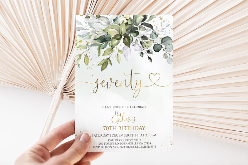 May include: A rectangular birthday invitation card featuring a watercolor illustration of green leaves and gold flecks at the top. The text reads: seventy, PLEASE JOIN US TO CELEBRATE, Esther's 70TH BIRTHDAY, SATURDAY | DECEMBER 12TH | AT 2:00PM, TWELVE COUNTRY CLUB, 1200 FOREST RD. LOS ANGELES, CA 07854, RSVP TO JENN AT 7771234567BY DECEMBER 5TH.