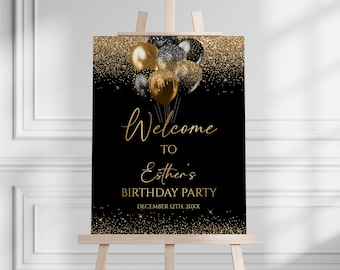 May include: A rectangular birthday party welcome sign featuring a black background with gold glitter accents at the top and bottom. A cluster of black and gold balloons sits at the top. The text reads: Welcome TO Esther's BIRTHDAY PARTY DECEMBER 12TH, 20XX.
