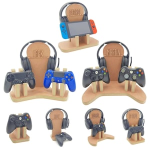 May include: A set of six wooden gaming console stands, each with a personalised nameplate. The stands feature a headset holder, a controller holder, and a space for a gaming console. The names on the stands are "George", "Jack", and "Martin".