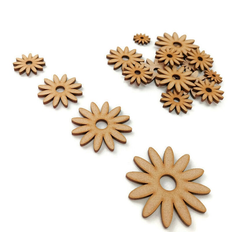 May include: A collection of wooden flower shapes in various sizes. The flowers are light brown and have a simple, elegant design.