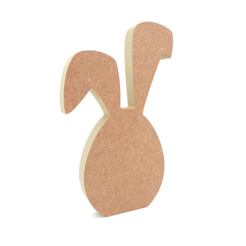 May include: A wooden bunny rabbit cutout with a brown stain. The bunny has large ears and a round body.