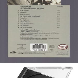 May include: A CD case for the album Now, Voyager: The Classic Film Scores of Max Steiner. The cover features a black and white film still of a man lighting a cigarette for a woman in a hat. The back lists track titles, credits, and a barcode.