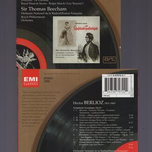 May include: A vintage EMI Classics CD featuring Berlioz's Symphonie Fantastique, conducted by Sir Thomas Beecham. The album cover displays a portrait of a man and a woman, with text in English and French. The CD case measures approximately 5 x 5 inches.