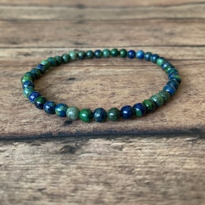 May include: A blue and green gemstone bracelet with small round beads.