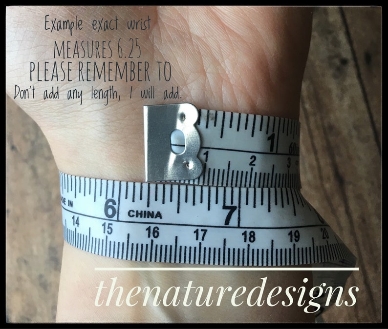 May include: A white measuring tape wrapped around a wrist, showing a measurement of 6.25 inches. The text "Example exact wrist MEASURES 6.25 PLEASE REMEMBER TO Don't add any length, I will add." is visible above the tape.