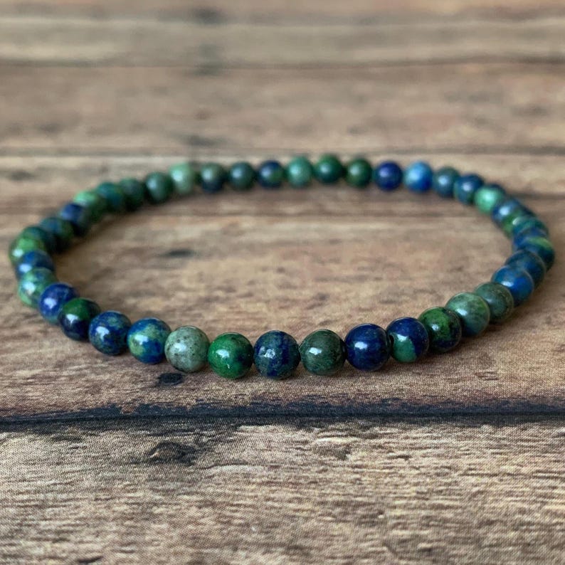 May include: A blue and green gemstone bracelet with small round beads.
