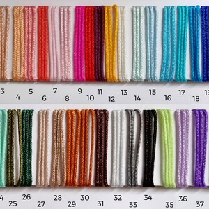 May include: A chart displaying 39 different coloured cords, each labelled with a number from 1 to 39. The cords are arranged in two rows, with the first row containing cords numbered 1 to 21 and the second row containing cords numbered 22 to 39.