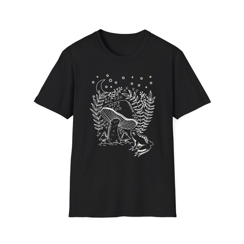 May include: Black t-shirt with a white outline of a mushroom, a frog, and foliage. The design is reminiscent of a fairytale forest.