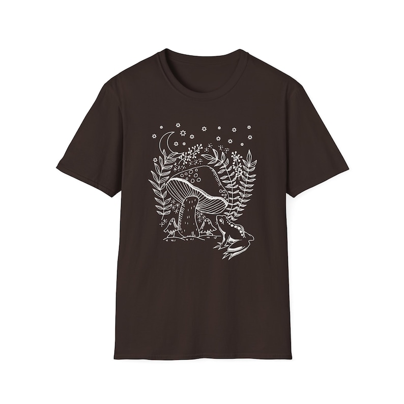 May include: A dark brown t-shirt with a white outline of a mushroom, leaves, and a frog in a forest setting. The design includes a crescent moon and stars.