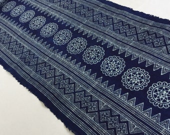 May include: A blue cotton fabric with a white geometric pattern. The pattern includes circles, triangles, and squares.