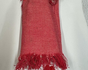May include: Red doll dress with a fringe hem and a pair of red shoes.