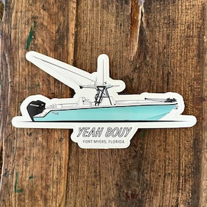 May include: A white sticker with a blue and white illustration of a boat with the text "YEAH BOUY" and "FORT MYERS, FLORIDA" underneath.