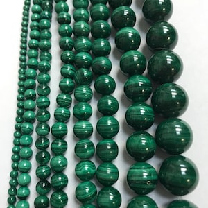 May include: A set of green malachite beads in various sizes. The beads are round and have a smooth, polished finish. The beads are strung on a string and are ready to be used for jewelry making.