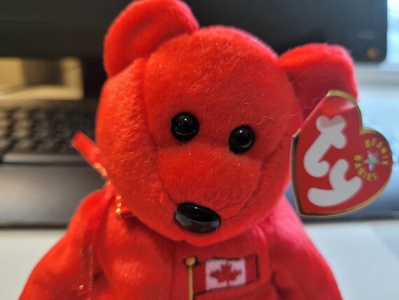 Ty Beanie Babies Pierre Red Canadian Bear, Canadian Flag On Chest, And Red Ribbon Around Neck.