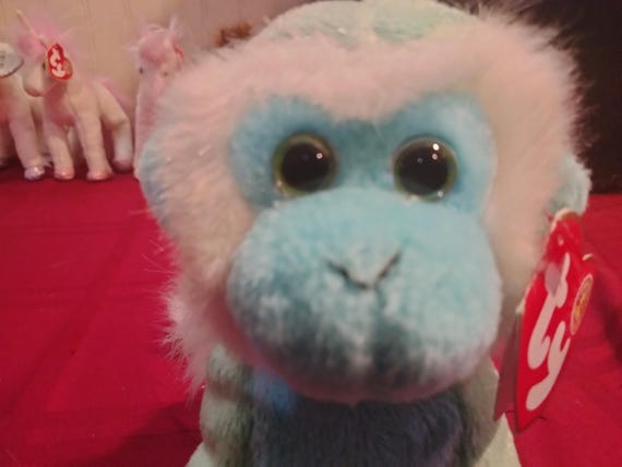 Ty Beanie Babies Zoomer The Cute Green And Light Blue Monkey With Winning Smile, BBOM Button On Left Upper Leg, And White Fur Back And Tail