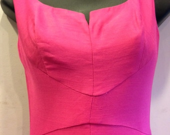 May include: A sleeveless, hot pink dress with a V-neckline and a fitted bodice.