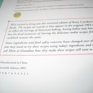 May include: A page from a cookbook with text. The text reads "Betty Crocker's Cooky Book" and mentions recipes from a 1963 cookbook. The page also includes the text "Manufactured in China" and "Facsimile Edition 2002".