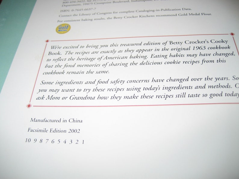May include: A page from a cookbook with text. The text reads "Betty Crocker's Cooky Book" and mentions recipes from a 1963 cookbook. The page also includes the text "Manufactured in China" and "Facsimile Edition 2002".