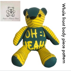 May include: A handmade teddy bear with a green body and yellow striped limbs. The bear has the words "OH :) YEAH" in yellow on its chest. The bear's ears and paws are green. A small drawing of a bear is in the upper left corner with the text "Annie's Memory Bears".