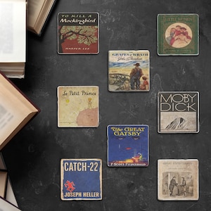 May include: Nine vintage book covers printed on square coasters. The coasters feature classic novels such as "To Kill a Mockingbird", "The Grapes of Wrath", "Moby Dick", "Catch-22", "The Great Gatsby", "Little Women", "Great Expectations", and "Le Petit Prince".