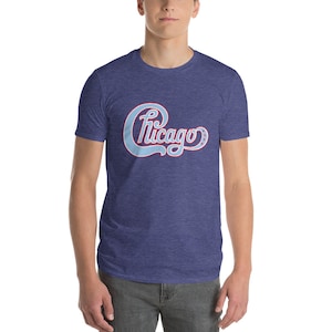 May include: A blue heather t-shirt with a light blue and red "Chicago" logo printed on the front.