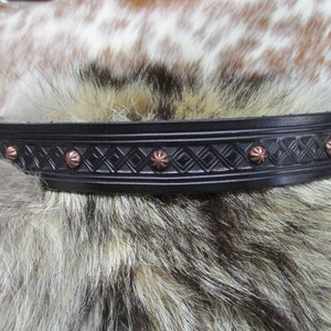 May include: Black leather belt with a diamond pattern and copper rivets.