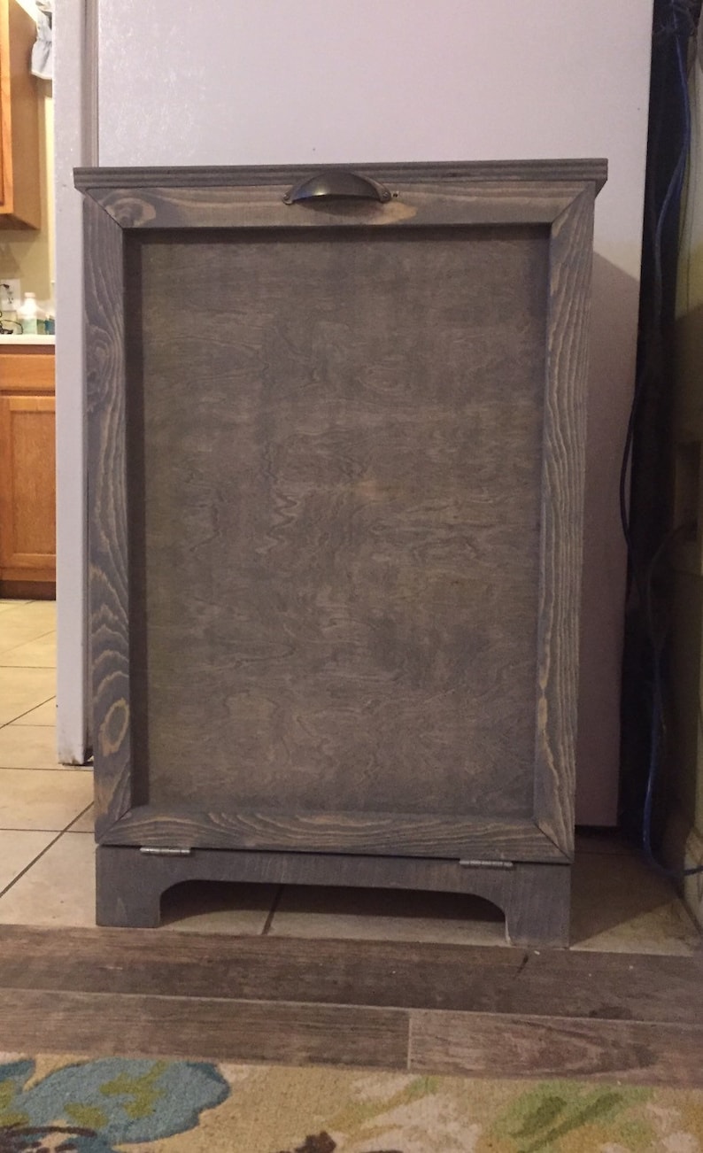 May include: A grey wooden bin with a hinged door and a metal handle. The bin has a simple design and is made from reclaimed wood.
