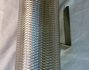 May include: A silver guiro percussion instrument with a textured, woven pattern on the cylindrical body. The instrument has a conical base and a handle. The guiro is used to create rhythmic sounds.