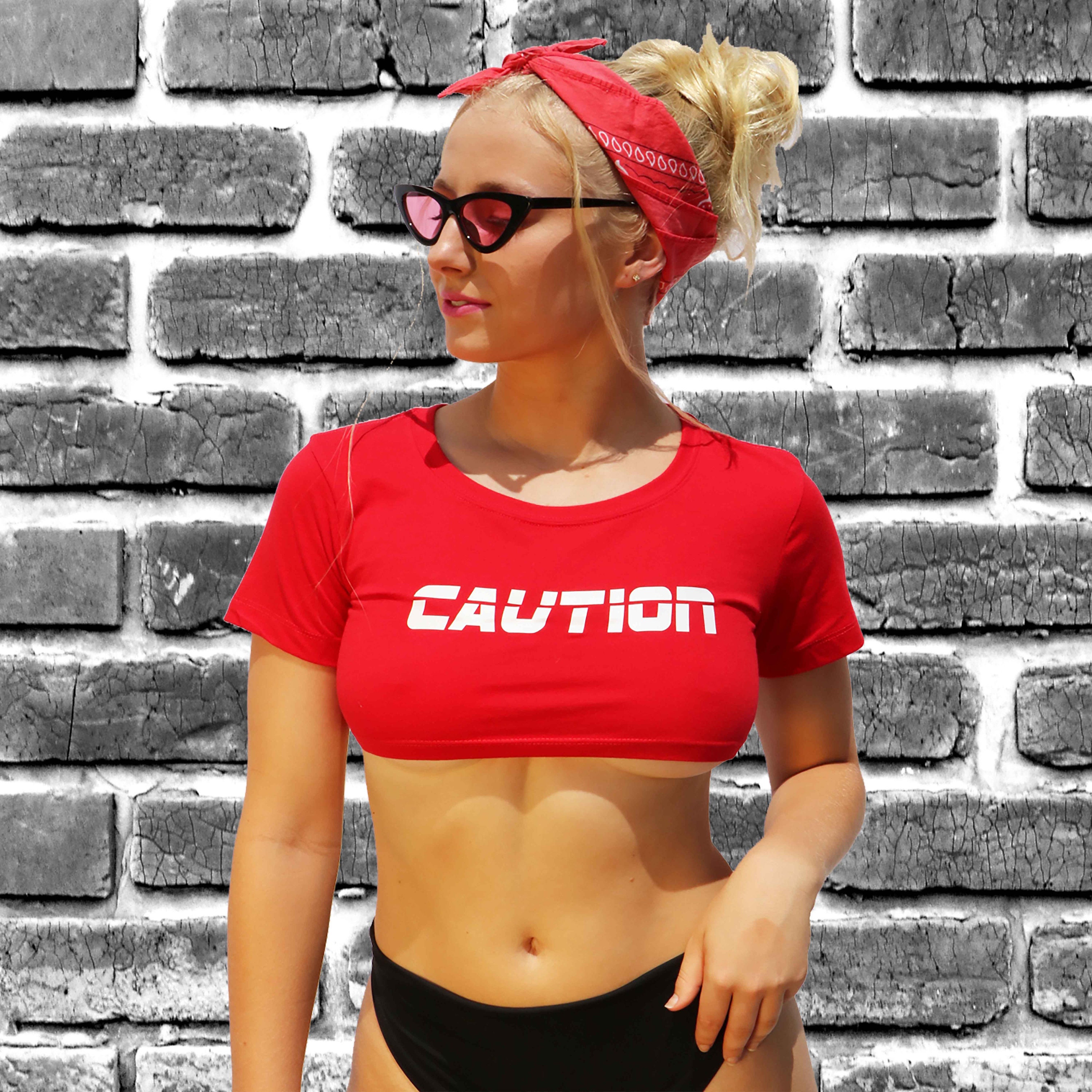 This adorable CAUTION underboob crop top is perfect to wear to a rave or yo...