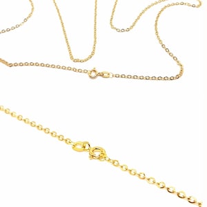 May include: Close-up of several delicate gold-colored chain necklaces. The chains have a fine, linked design and are shown against a white background. Each necklace features a clasp for secure fastening. The chains are likely for jewelry making or wearing.